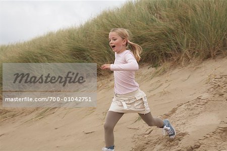 Girl Running Down Sand Dune