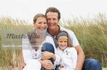 Portrait of Family Sitting on Beach
