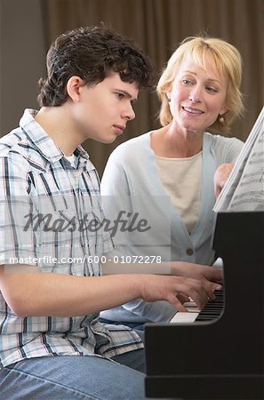 Boy Playing Piano for Woman