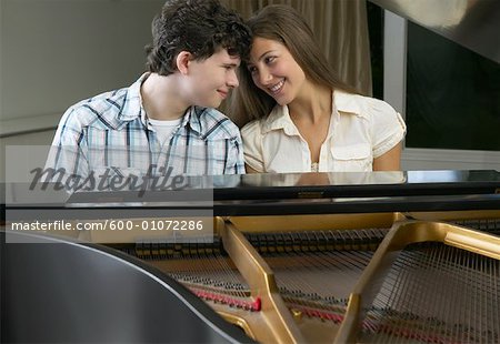 Boy and Girl Playing Piano Together