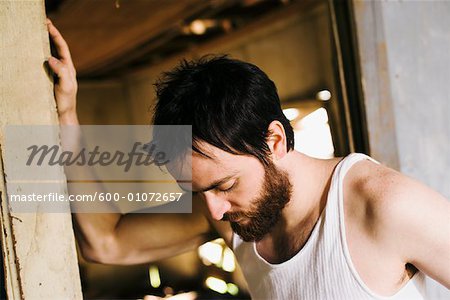 Man in Doorway of Decrepit House