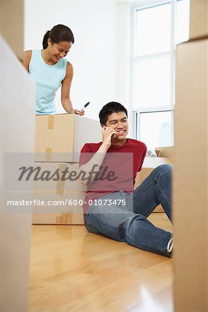 Woman Packing, Man on Cellular Phone