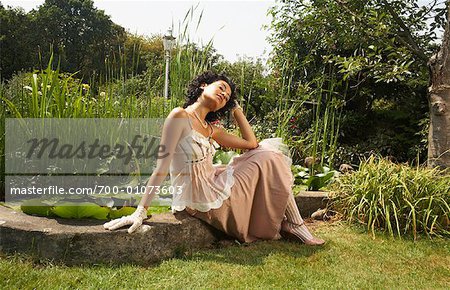 Woman Sitting By Pond
