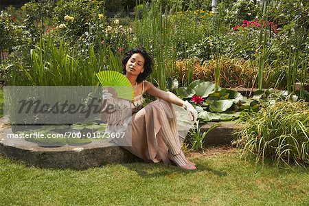 Woman Sitting By Pond, Fanning Herself