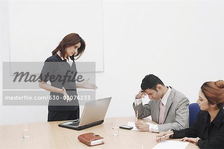 Businesswoman shouting at a businessman