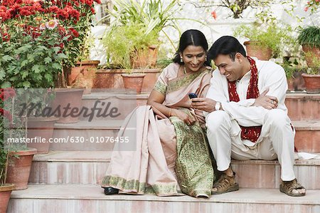 Mid adult couple looking at a mobile phone