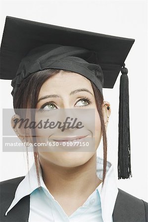 Close-up of a female graduate looking up