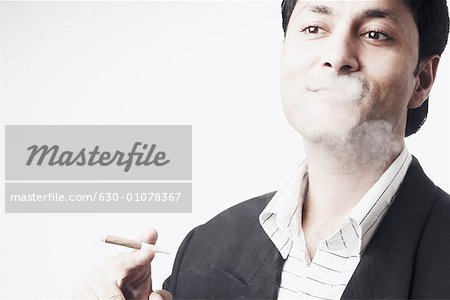 Close-up of a businessman smoking a cigar