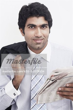 Portrait of a businessman holding a newspaper