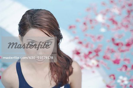 High angle view of a young woman standing in a swimming pool