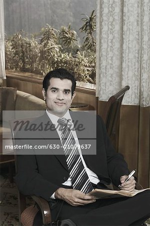 Portrait of a businessman holding a newspaper