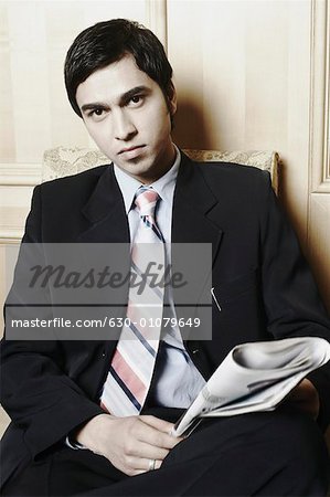 Portrait of a businessman holding a newspaper