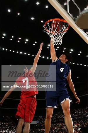 Young Asian basketball player making a dunk