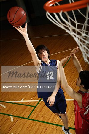 Young Asian basketball players on court