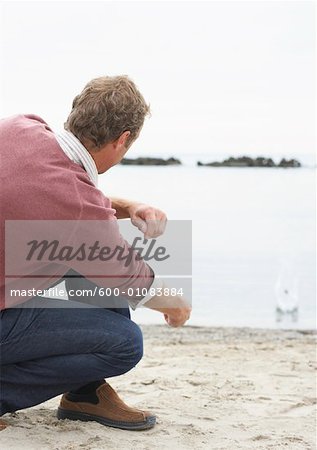 Man Throwing Rocks at the Beach, Sunnyside Park, Toronto, Ontario, Canada