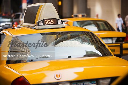 Reflection of buildings on the windshield of a yellow taxi, New York City, New York State, USA