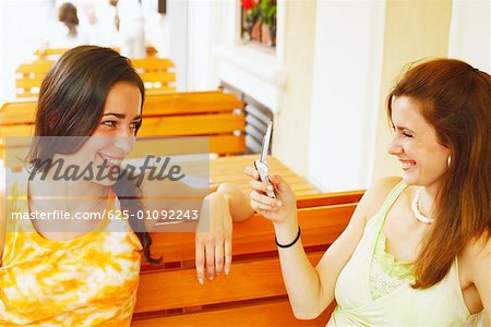 Close-up of two young women sitting in a restaurant