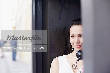 Young woman in a telephone booth