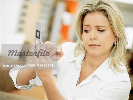 Close-up of a mid adult woman operating a mobile phone