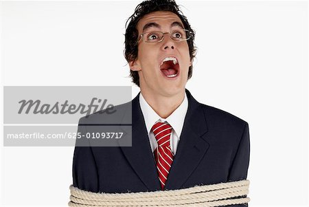 Close-up of a businessman tied up with rope