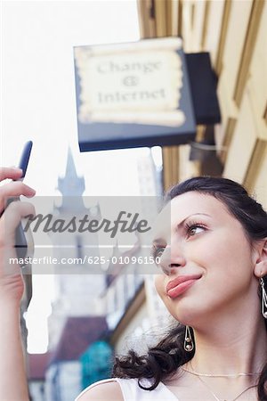 Low angle view of a young woman looking at a mobile phone