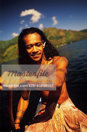 Close-up of a young man rowing a boat, Hawaii, USA