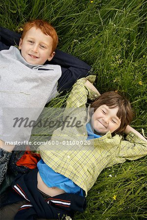Portrait of Boys Lying Down in Field of Grass