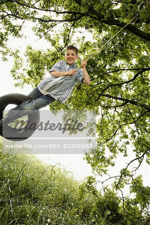 Boy Swinging on Tire Swing