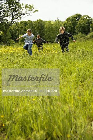 Boys Running Through Field