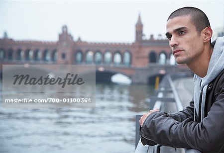 Man Looking at the River Spree, Oberbaumbrucke Bridge in Background, Berlin, Germany