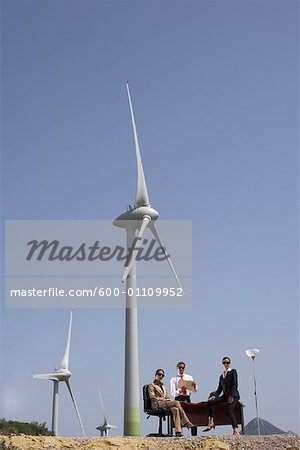 Business People at Desk by Wind Farm