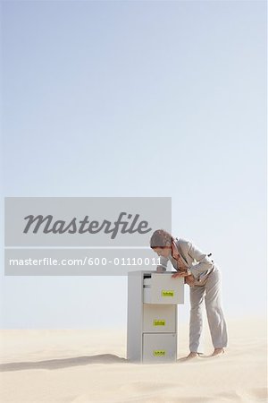 Business Woman and Filing Cabinet in Desert