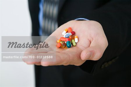 Businessman with Handful of Pills