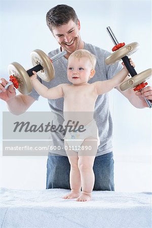 Father and Son Playing with Weights
