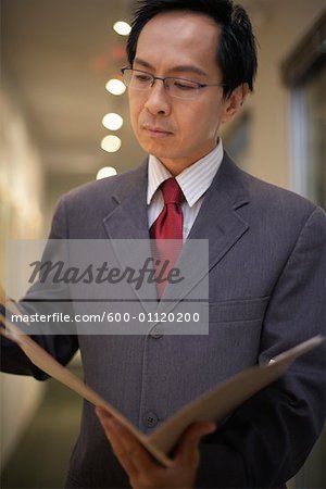 Businessman Looking at File Folder