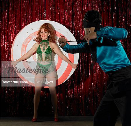 Performer Throwing Knives at Showgirl on Stage