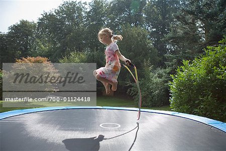 Girl Jumping Rope on Trampoline