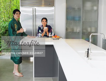 Couple Drinking Coffee in Kitchen