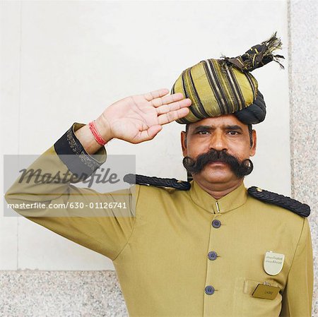 Portrait of a security guard saluting