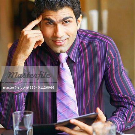 Portrait of a businessman sitting in a restaurant and smiling