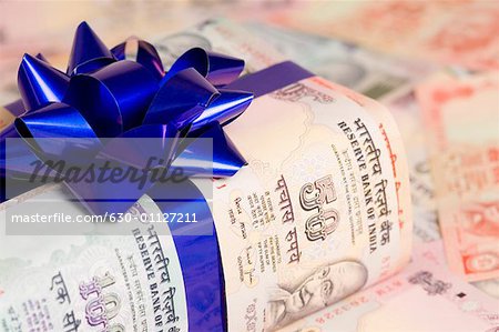 Close-up of Indian banknotes tied with a ribbon