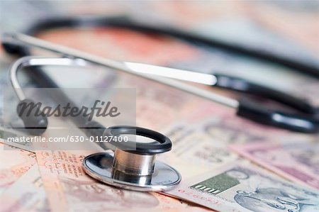 Stethoscope on Indian banknotes of different denominations