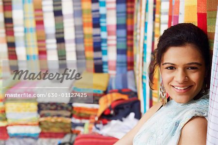 Portrait of a young woman smiling in a clothing store