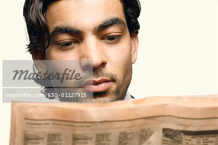 Close-up of a businessman reading a newspaper