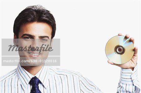 Portrait of a businessman holding a CD and smiling