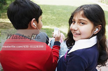 Porträt eines Mädchens und ihrem Bruder einen MP3-Player anhören