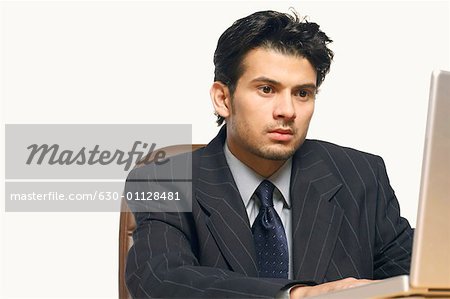 Close-up of a businessman using a laptop