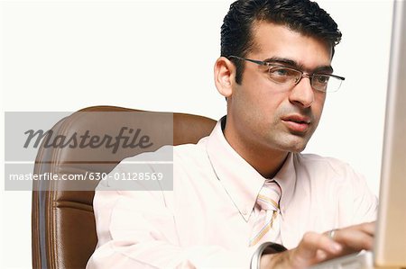 Close-up of a young man using a laptop