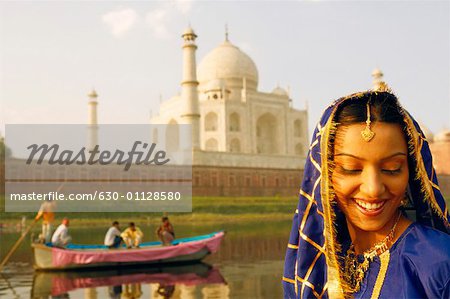 Close-up of a young woman smiling Taj Mahal, Agra, Uttar Pradesh, India