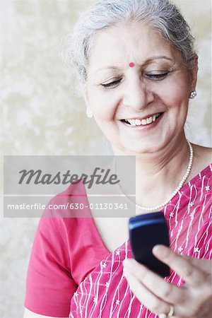 Close-up of a mature woman holding a mobile phone